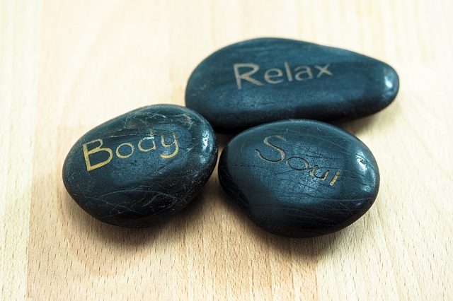 Three black stones with the words "Body," "Relax," and "Soul" etched in gold.